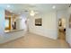 Open-concept living area with views of the kitchen, front entry, and a neutral color palette at 8303 Sw 78Th Cir, Ocala, FL 34476