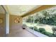 Relaxing screened patio with ceiling fan and view of lush backyard landscaping at 8303 Sw 78Th Cir, Ocala, FL 34476