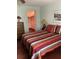 Well-lit bedroom with a view of an open closet featuring a decorative wood dresser at 8450 Sw 90Th St # D, Ocala, FL 34481