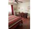 Comfortable bedroom with hardwood floors, large window, and an office desk at 8450 Sw 90Th St # D, Ocala, FL 34481