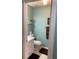 Neat half bathroom featuring a white vanity and toilet with light blue colored walls at 8450 Sw 90Th St # D, Ocala, FL 34481