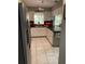 Bright kitchen featuring a stainless steel refrigerator, white cabinets, and a window overlooking the yard at 8450 Sw 90Th St # D, Ocala, FL 34481