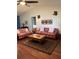 Comfortable living room with hardwood floors, traditional rug, and lots of seating at 8450 Sw 90Th St # D, Ocala, FL 34481