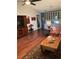 Open-concept living room with hardwood floors, ceiling fan, and easy access to the kitchen at 8450 Sw 90Th St # D, Ocala, FL 34481