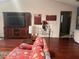 Comfortable living room with rich wood floors, a large entertainment center, and inviting furniture at 8450 Sw 90Th St # D, Ocala, FL 34481
