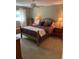 Comfortable bedroom featuring a queen bed, neutral walls, ceiling fan, and two bedside tables at 8450 Sw 90Th St # D, Ocala, FL 34481