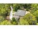 Aerial view of a home highlighting landscaping, detached garage, and circular driveway at 8605 Sw 209Th Court Rd, Dunnellon, FL 34431