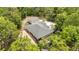 Aerial view of home surrounded by trees with a detached garage and circular driveway at 8605 Sw 209Th Court Rd, Dunnellon, FL 34431