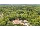 Aerial view featuring a private backyard pool surrounded by lush greenery at 8605 Sw 209Th Court Rd, Dunnellon, FL 34431