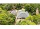 Aerial view of home with detached garage, outdoor patio, and manicured landscaping at 8605 Sw 209Th Court Rd, Dunnellon, FL 34431