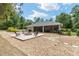 Backyard with a fire pit, seating, and a screened-in patio for relaxation at 8605 Sw 209Th Court Rd, Dunnellon, FL 34431