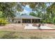 Well maintained backyard with fire pit, screened patio, and ample space for entertaining at 8605 Sw 209Th Court Rd, Dunnellon, FL 34431