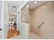 Bright bathroom featuring tiled shower and access to hallway, neutral color palette at 8605 Sw 209Th Court Rd, Dunnellon, FL 34431