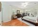 Spacious main bedroom with hardwood floors, ceiling fan, and dresser at 8605 Sw 209Th Court Rd, Dunnellon, FL 34431