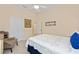 Bright bedroom features a closet, a ceiling fan, and a large floral-patterned bed at 8605 Sw 209Th Court Rd, Dunnellon, FL 34431