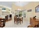 Inviting breakfast nook with chandelier and large windows to the outside at 8605 Sw 209Th Court Rd, Dunnellon, FL 34431