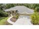 Exterior elevation showcasing a well-manicured front yard and inviting entryway at 8605 Sw 209Th Court Rd, Dunnellon, FL 34431