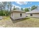 Rear exterior view featuring the home with well maintained lawn and neutral stucco at 8605 Sw 209Th Court Rd, Dunnellon, FL 34431