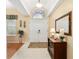 Well-lit foyer featuring tile flooring, a decorative mirror, and an arched transom window at 8605 Sw 209Th Court Rd, Dunnellon, FL 34431