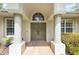 Home's front entrance with decorative columns and a arched window above double front doors at 8605 Sw 209Th Court Rd, Dunnellon, FL 34431