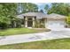 Beautiful home with a manicured lawn, three car garage and mature landscaping at 8605 Sw 209Th Court Rd, Dunnellon, FL 34431
