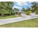 Charming single-story home with a three-car garage and a long driveway, nestled amongst mature landscaping at 8605 Sw 209Th Court Rd, Dunnellon, FL 34431
