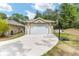 Detached garage with a basketball hoop, offering extra storage and recreational space for outdoor activities at 8605 Sw 209Th Court Rd, Dunnellon, FL 34431