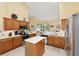 Bright eat-in kitchen featuring stainless steel appliances, wood cabinets and center island at 8605 Sw 209Th Court Rd, Dunnellon, FL 34431