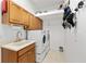 Laundry room features washer/dryer hookups, a utility sink, and tile flooring at 8605 Sw 209Th Court Rd, Dunnellon, FL 34431