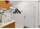 Laundry room features washer/dryer hookups, a utility sink, and tile flooring at 8605 Sw 209Th Court Rd, Dunnellon, FL 34431