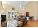 Comfortable living room features vaulted ceilings, ceiling fan, and hardwood floors at 8605 Sw 209Th Court Rd, Dunnellon, FL 34431