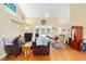 Open-concept living room with vaulted ceiling, ceiling fan, and hardwood floors at 8605 Sw 209Th Court Rd, Dunnellon, FL 34431