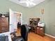Functional office space with ceiling fan, hardwood flooring, and natural light at 8605 Sw 209Th Court Rd, Dunnellon, FL 34431