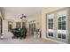 Large screened patio with dining area, bench, and access to outdoor living at 8605 Sw 209Th Court Rd, Dunnellon, FL 34431