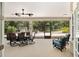 Screened patio offers ample seating with a dining table and two comfortable lounge chairs at 8605 Sw 209Th Court Rd, Dunnellon, FL 34431