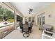 Spacious screened patio with outdoor dining set and ceiling fans for comfortable living at 8605 Sw 209Th Court Rd, Dunnellon, FL 34431