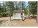 Backyard shed with double doors surrounded by mature trees and foliage at 8605 Sw 209Th Court Rd, Dunnellon, FL 34431