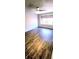 Cozy bedroom featuring wood floors, a ceiling fan, and a bright window at 8771 Sw 115Th St, Ocala, FL 34481