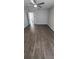 A bedroom featuring wood floors, ceiling fan, neutral paint, and closet and hallway access at 8771 Sw 115Th St, Ocala, FL 34481