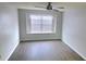 Bedroom featuring wood floors, ceiling fan, and bright window at 8771 Sw 115Th St, Ocala, FL 34481