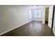 Bedroom with hard surface floors, a closet, and two large windows for lots of natural light at 8771 Sw 115Th St, Ocala, FL 34481