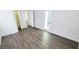 A bedroom with hard surface floors, a ceiling fan, and a patio door and closet at 8771 Sw 115Th St, Ocala, FL 34481