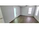Large bedroom with lots of natural light, wood-look floors, ceiling fan, and a patio door at 8771 Sw 115Th St, Ocala, FL 34481