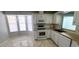 Kitchen with white cabinetry, tile backsplash, stainless steel appliances, and a bay window for natural light at 8771 Sw 115Th St, Ocala, FL 34481
