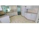 Bright kitchen featuring white appliances, a modern sink, and stylish cabinets at 8771 Sw 115Th St, Ocala, FL 34481