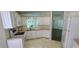 Bright kitchen featuring white appliances, a modern sink, and stylish cabinets at 8771 Sw 115Th St, Ocala, FL 34481