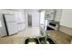Bright kitchen features white appliances, marbled countertops, and tiled floors, perfect for Gathering meals at 8771 Sw 115Th St, Ocala, FL 34481