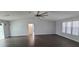 Spacious living room featuring hardwood floors, ceiling fan, and natural light at 8771 Sw 115Th St, Ocala, FL 34481
