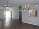 Sun-drenched living room with hardwood floors and modern lighting fixtures at 8771 Sw 115Th St, Ocala, FL 34481