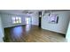 Open-concept living room featuring modern flooring, pendant lighting and access to the front door at 8771 Sw 115Th St, Ocala, FL 34481